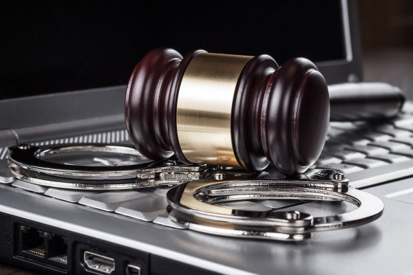 Handcuffs, gavel, and computer - Cyber Related Laws